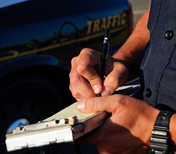Cop writing ticket 570x498