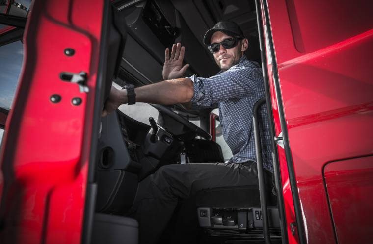 Semi truck driver waving (1)